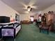 Spacious living room featuring a ceiling fan, a large rug, and furniture at 3143 Cedar St, Scottdale, GA 30079