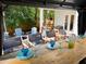 Covered patio featuring a dining table set for a meal, with additional seating surrounding a fire pit at 550 Quillian Ave, Decatur, GA 30032