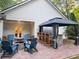 Outdoor living space with brick patio, fire pit, bar area, and comfortable seating, perfect for entertaining at 550 Quillian Ave, Decatur, GA 30032