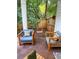 Cozy outdoor area with comfortable chairs, throw pillows, and a charming swing, ideal for relaxation at 550 Quillian Ave, Decatur, GA 30032