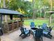 Outdoor entertaining space with a gazebo, fire pit, Adirondack chairs, and sport court at 550 Quillian Ave, Decatur, GA 30032