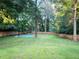 Large backyard featuring a full basketball court surrounded by a wooden fence at 550 Quillian Ave, Decatur, GA 30032