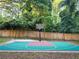 Outdoor basketball court with green and red surface surrounded by a wooden fence and lush greenery at 550 Quillian Ave, Decatur, GA 30032