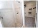 Bathroom featuring a glass-enclosed tiled shower with tiled floors, plus a view into the walk-in closet at 550 Quillian Ave, Decatur, GA 30032