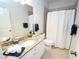 Well-lit bathroom featuring a granite countertop, white cabinets, and neutral-toned tile at 550 Quillian Ave, Decatur, GA 30032