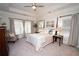 A bright main bedroom with a trey ceiling, four-post bed and large windows with natural light at 550 Quillian Ave, Decatur, GA 30032