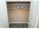 Open closet with storage shelf and modern gray flooring at 550 Quillian Ave, Decatur, GA 30032