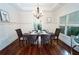 Elegant dining room with wainscoting, hardwood floors, and a modern chandelier at 550 Quillian Ave, Decatur, GA 30032
