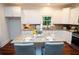 Updated kitchen with white cabinetry, granite counters, and a functional island at 550 Quillian Ave, Decatur, GA 30032