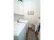 A well-lit laundry room with white washer and dryer, storage, and decor accents at 550 Quillian Ave, Decatur, GA 30032