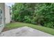Grassy backyard bordered by mature trees providing privacy and shade to the home at 5937 Yellowood Ct, Atlanta, GA 30349