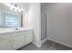 Bright bathroom features white cabinets, shower, and vinyl floors at 5937 Yellowood Ct, Atlanta, GA 30349