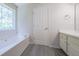 Bright bathroom features soaking tub and vinyl floors at 5937 Yellowood Ct, Atlanta, GA 30349