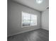 A bedroom features a large window, laminate floors, and neutral paint at 5937 Yellowood Ct, Atlanta, GA 30349