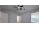 Spacious bedroom with plush carpeting, two windows, and ceiling fan at 5937 Yellowood Ct, Atlanta, GA 30349
