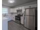 Modern kitchen with stainless steel appliances, white cabinets, and marble countertops at 5937 Yellowood Ct, Atlanta, GA 30349