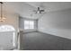 Spacious living room with a ceiling fan and great natural light from the large window at 5937 Yellowood Ct, Atlanta, GA 30349