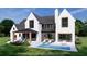 This is an exterior rendering of a modern home with white brick, a covered patio, and an in-ground pool at 7160 Shady Grove Rd, Cumming, GA 30041