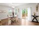 Dining area featuring a round table, contemporary light fixture, and sliding door access to the deck at 1049 Climbing Rose Way, Mcdonough, GA 30253