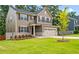 View of a two-story home featuring a well-manicured lawn and a two-car garage at 1049 Climbing Rose Way, Mcdonough, GA 30253