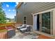 Relaxing outdoor deck with comfortable seating and view of the backyard at 1049 Climbing Rose Way, Mcdonough, GA 30253