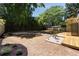 Backyard featuring a stone walkway, wooden deck, mature trees, and landscaped mulch beds at 1130 Mclinden Se Ave, Smyrna, GA 30080