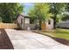 Charming single-story home featuring a stone facade, new driveway and a well-manicured front yard at 1130 Mclinden Se Ave, Smyrna, GA 30080