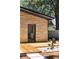 Stylish home with stone exterior and wooden deck leading to the entrance, complemented by a beautifully landscaped yard at 1130 Mclinden Se Ave, Smyrna, GA 30080