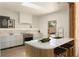 Bright kitchen featuring white cabinets, stainless steel appliances, and a cozy breakfast bar at 1130 Mclinden Se Ave, Smyrna, GA 30080