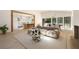 Open living room features a stone wall, beamed entryway, a tan sectional sofa, and dining area beyond at 1130 Mclinden Se Ave, Smyrna, GA 30080