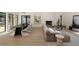 Sunlit living room and dining area with a stylish sofa, fireplace, and hardwood floors at 1130 Mclinden Se Ave, Smyrna, GA 30080