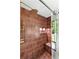 Elegant shower with rainfall shower head, built-in bench, and glass door at 1130 Mclinden Se Ave, Smyrna, GA 30080