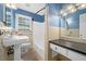 A cozy bathroom with a tiled shower and tub combination, vanity, and a large window at 1425 Dalewood Ne Dr, Atlanta, GA 30329