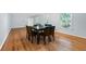 A spacious dining room with wood floors, a modern table, and large windows offering ample natural light at 1425 Dalewood Ne Dr, Atlanta, GA 30329