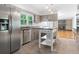 Open kitchen featuring stainless steel appliances, kitchen island, and stone floors at 1425 Dalewood Ne Dr, Atlanta, GA 30329