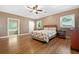 A bright main bedroom with wood floors, a ceiling fan, and an en-suite bath featuring a soaking tub at 1425 Dalewood Ne Dr, Atlanta, GA 30329