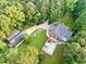 Stunning aerial view of a home showcasing its swimming pool, spacious backyard, and lush, mature landscaping at 2230 Ewing Chapel Rd, Dacula, GA 30019