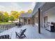 Wide back deck featuring an outdoor kitchen, dining area, covered porch, and railing overlooking the yard at 2230 Ewing Chapel Rd, Dacula, GA 30019
