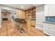 Entertainer's basement bar area with stone fireplace, beverage fridge, and wood counters at 2230 Ewing Chapel Rd, Dacula, GA 30019