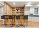 Basement bar area featuring wood counters, display shelving, seating and wet bar at 2230 Ewing Chapel Rd, Dacula, GA 30019