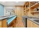 Basement bar with beverage fridge, display shelves, and wood-look flooring at 2230 Ewing Chapel Rd, Dacula, GA 30019