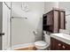 Cozy bathroom with a new vanity, toilet, shower with a tile backsplash and a wooden accent cabinet at 2230 Ewing Chapel Rd, Dacula, GA 30019