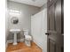Cozy bathroom with pedestal sink, commode, and shower featuring a white curtain at 2230 Ewing Chapel Rd, Dacula, GA 30019