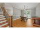 Bright dining room with hardwood floors, modern lighting, and a staircase on the side at 2230 Ewing Chapel Rd, Dacula, GA 30019
