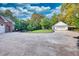 The driveway leads to the house with a detached three-car garage and additional carport at 2230 Ewing Chapel Rd, Dacula, GA 30019