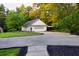 A long concrete driveway leads to a detached three-car garage with an additional carport at 2230 Ewing Chapel Rd, Dacula, GA 30019