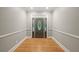 Inviting home foyer featuring beautiful hardwood floors, neutral walls, and stylish front door at 2230 Ewing Chapel Rd, Dacula, GA 30019