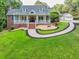 Charming two-story home with a well-manicured lawn, inviting front porch, and a circular driveway at 2230 Ewing Chapel Rd, Dacula, GA 30019