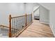Hallway with wood floors, base molding, and a view into the bedroom featuring a bed with gray bedding at 2230 Ewing Chapel Rd, Dacula, GA 30019