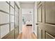 Hallway offers a peek into a bedroom and features hardwood floors and stylish doors at 2230 Ewing Chapel Rd, Dacula, GA 30019